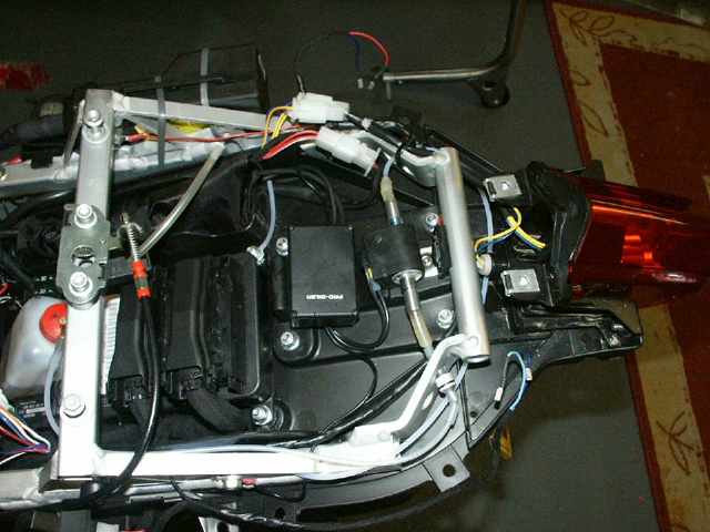 You can see the container, pump and junction box.
Also it is easy to see where to tap the 12 V power from the rear light (yellow wire) overview_connections.jpg