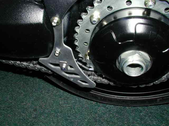 On all the single-sided swingarm Triumphs, there is only the narrowest channel (3-4mm) for the nozzle outlets to run in without contacting the flanges (on the inside), or sprocket bolts (on the outside).
This nozzle design is rigid and locates the outlets precisely. nozzle.jpg